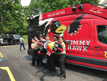 Explorer Photo 4 Police cadets lift a mascot off the ground at a special event