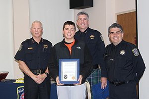 A proud CPA graduate holds a certificate and poses with NPD staff